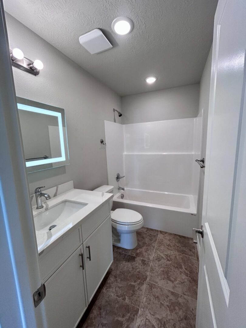 Modern bathroom with tub and vanity.