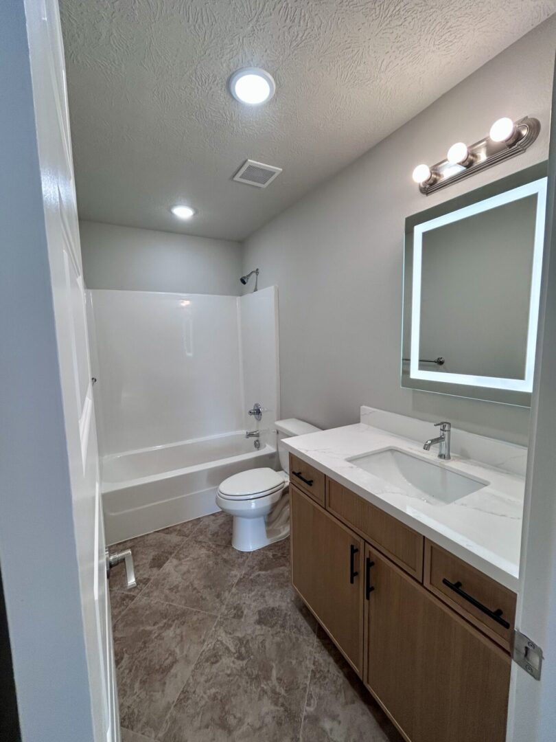 Modern bathroom with vanity and bathtub.