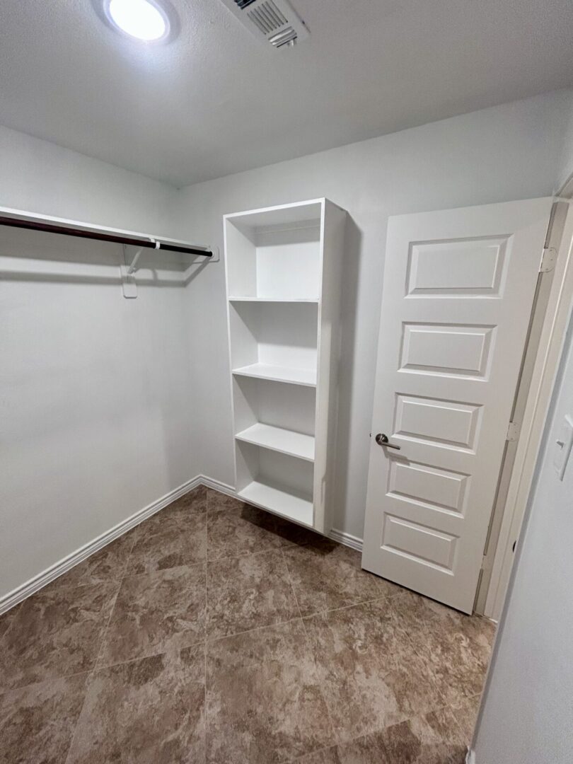 Small empty closet with shelves and rod.