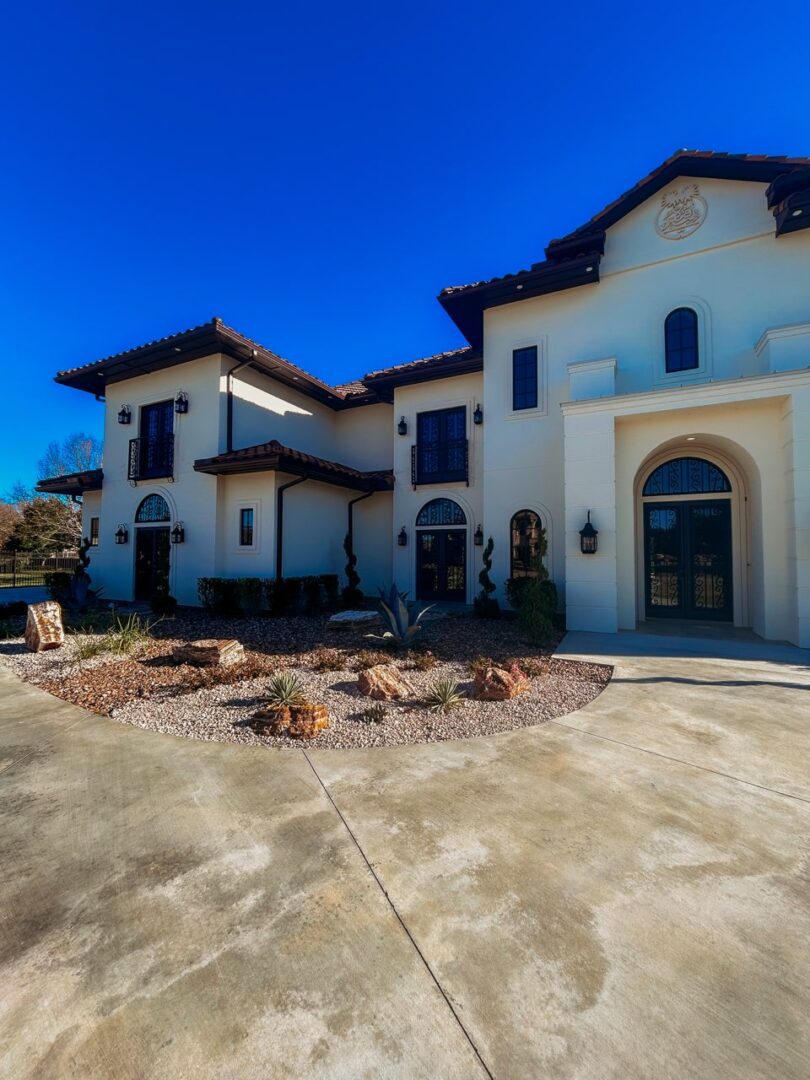Large Mediterranean-style house under clear sky.