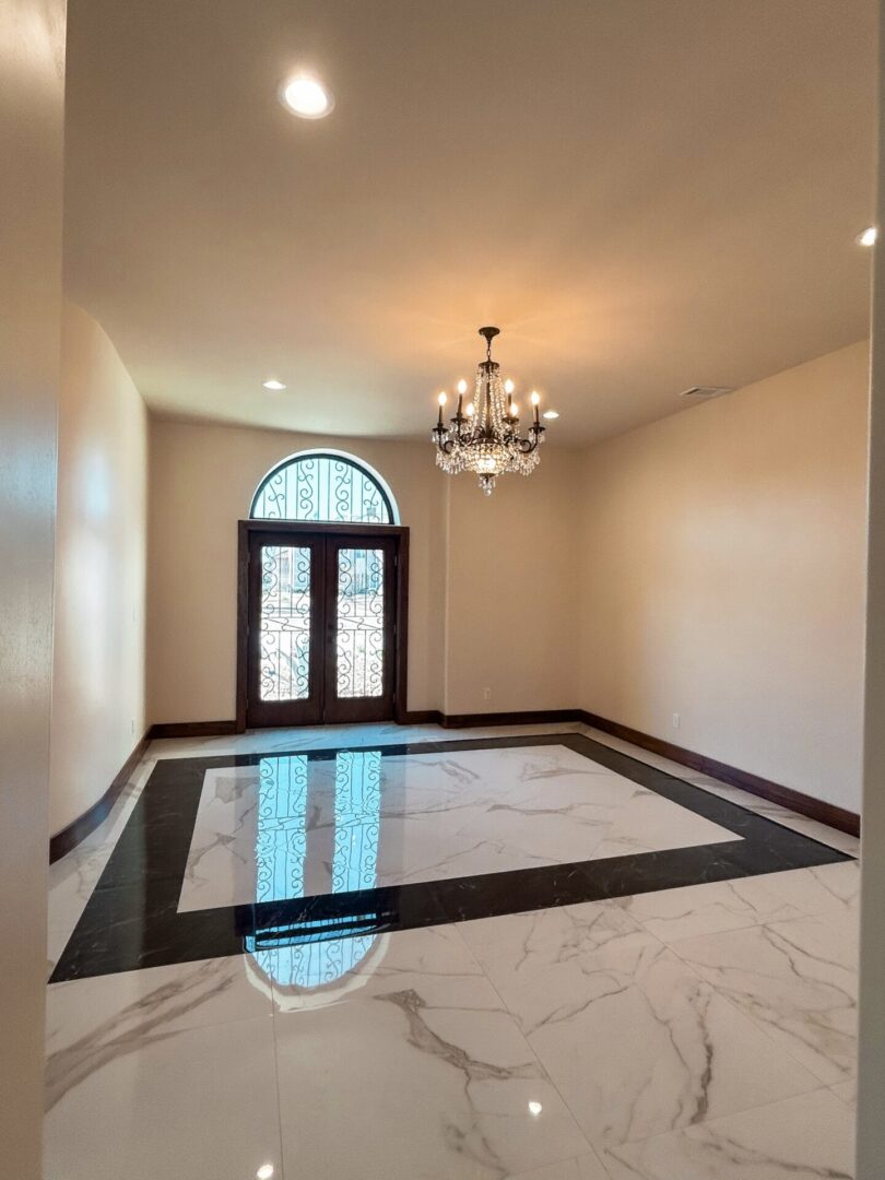 Elegant room with chandelier and marble floor.