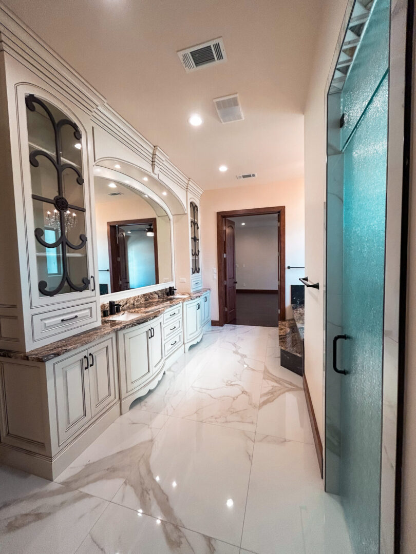 Elegant bathroom with marble floor and cabinets.