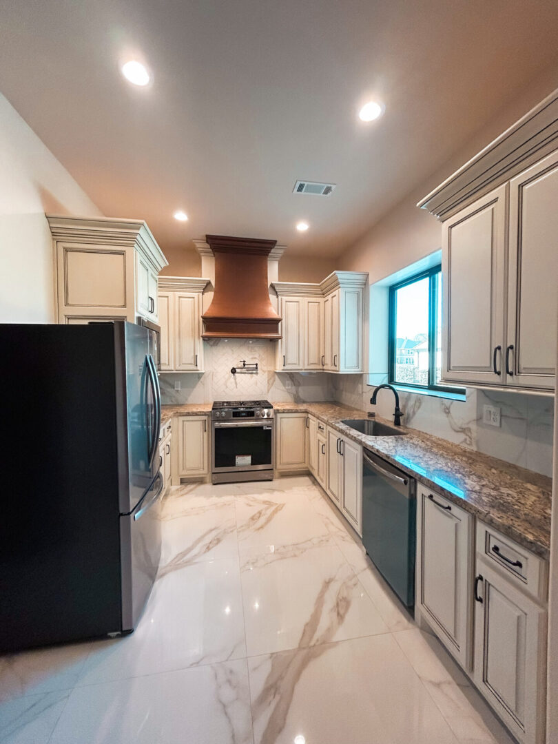 Modern kitchen with marble floor and countertops.